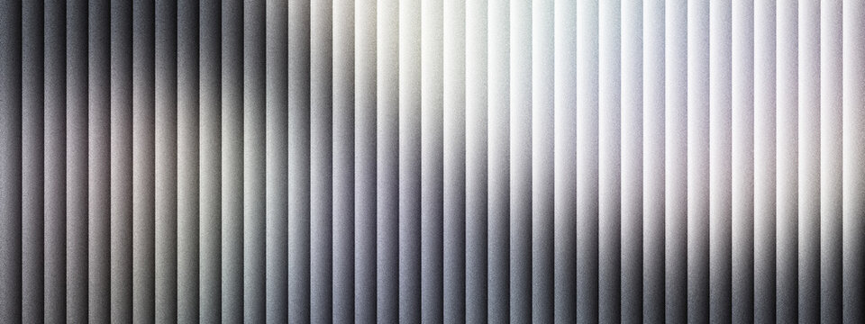 Industrial corrugated metal texture with vertical lines, brushed silver steel background with soft light reflections, metallic aluminum panel surface for architectural design and web banners.