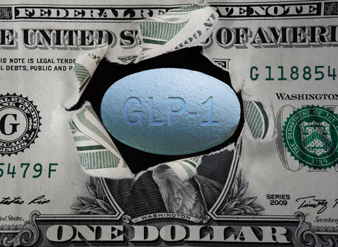 GLP-1 pill in a torn dollar bill