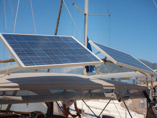 Modern sailing boat features solar panel system on deck for sustainable power supply. Renewable energy technology provides electricity for yacht systems during long sea voyages in Turkey. © Seleznov_Molchanova