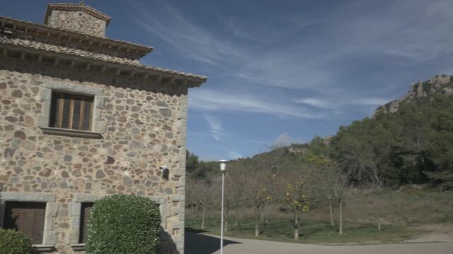 Building Sant Llorenc mountain sky clouds jib crane Polecam pan right 2