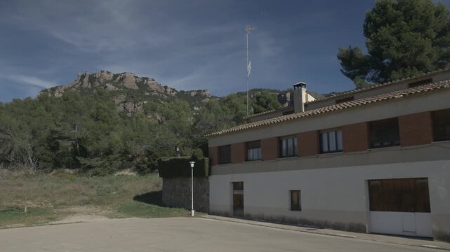 Buildings Sant Llorenc mountain sky clouds jib crane Polecam pan left