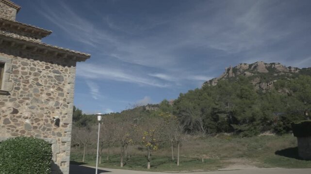 Sant Llorenc mountain sky clouds jib crane Polecam buildings pan left 3