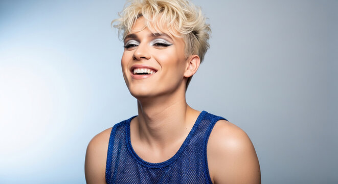 Young adult with blonde hair and dramatic eye makeup smiling, wearing a shimmering blue top, showcasing confidence and vivacity, suitable for beauty or lifestyle themes