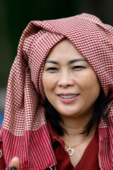 Naklejka premium Portrait of woman wearing the traditional Khmer Krama on her head. Siem Reap. Cambodia.
