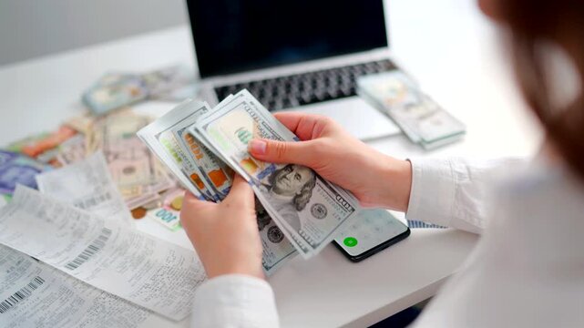 Woman calculating monthly home expenses, taxes and bank account balance.