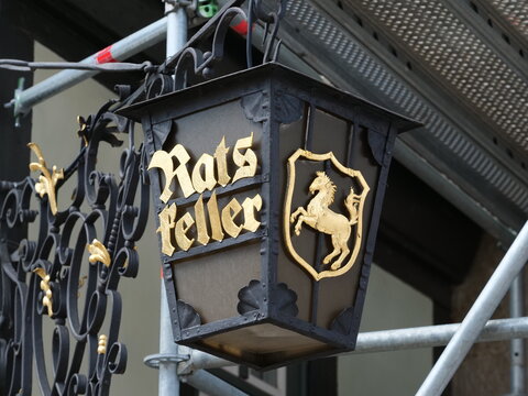 Germany, Wernigerode, May 17. 2026, An old lamp with gold lettering: Ratskeller, a traditional restaurant in a half-timbered building featuring a quaint vaulted cellar, home-style German cuisine