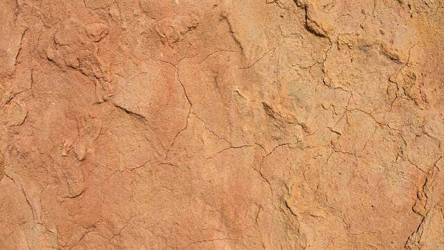Close up of dry cracked red clay earth texture