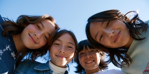 Obraz premium Close up group selfie of smiling children under sunny blue sky for website hero background and banner promoting friendship outdoor activity and youthful energy