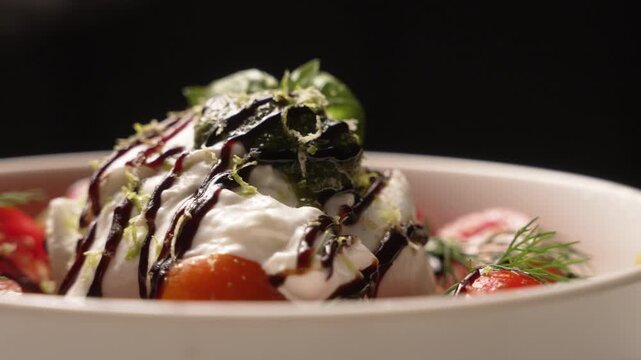 Appetizing Italian burrata cheese salad with cherry tomatoes, pesto, and balsamic vinegar, fa01