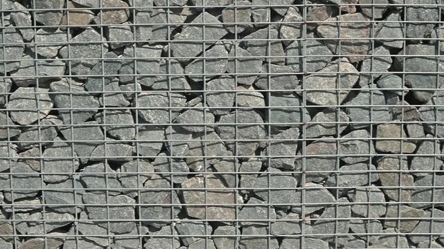 close-up view of gravel arranged in a grid pattern, emphasizing different stones and materials used in construction
