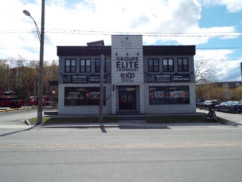 Gatineau, Quebec, Canada &ndash; April 20, 2026: A commercial building at 555 Bd Saint-Josephhousing "Groupe &Eacute;lite Arseneault Exp Agence Immobili&egrave;re and a local specialty market."