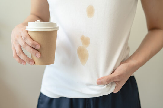 Clothes stain dirty from food concept, people get a coffee drop split from glass on the t-shirt.