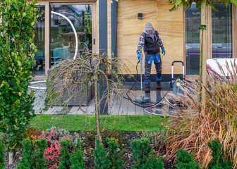 Fototapeta premium Cleaning the outdoor area while preparing for a gathering in a backyard