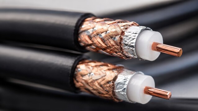 Close-up of coaxial cable with copper conductor and braided shielding for telecommunications and signal transmission, network infrastructure, and communication systems concept.