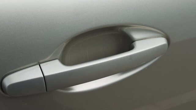 City car detail. Highdefinition photograph capturing smooth metal car door handle in city parking area