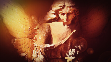 Obraz premium Gothic cemetery angel with illuminated wings and emotional atmosphere
