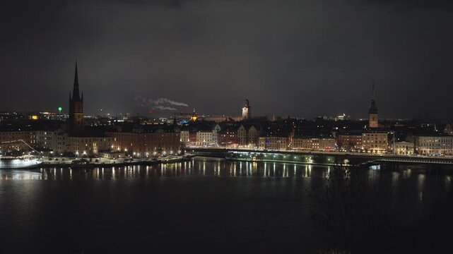 Stockholm city at night. Wide establishing static shot. Riddarholmen and slussen.