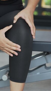 Women while exercising touching painful twisted or broken. Athlete training, running up and down stairs accident. Sport sprained sprain cause injury knee. and pain with leg bones.