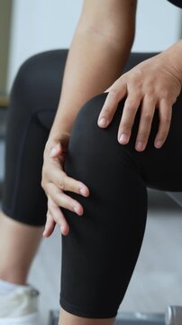 Women while exercising touching painful twisted or broken. Athlete training, running up and down stairs accident. Sport sprained sprain cause injury knee. and pain with leg bones.