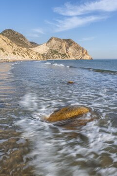 Rocks in the water, sandy beach with rocky cliffs, Paralia Paradisos, Kos, Dodecanese, Greece