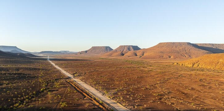 Aerial view, road leading through dry desert landscape, hills in Damaraland, Namibia