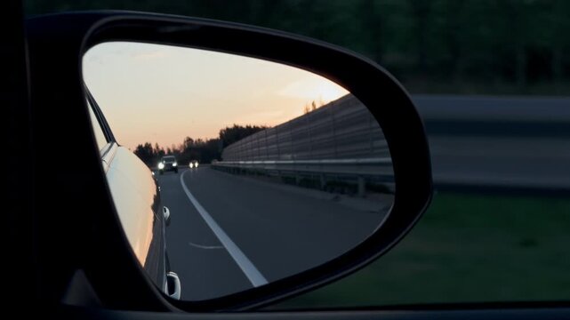 Quiet sunset reflection. Peaceful twilight shades reflected in vehicle mirrors while traveling gently