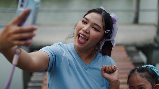 Asian woman vlogging and social media sharing with mobile phone, joyful lifestyle