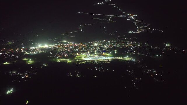 Aerial pan up revealing the glowing Vaishno Devi pilgrimage trail
