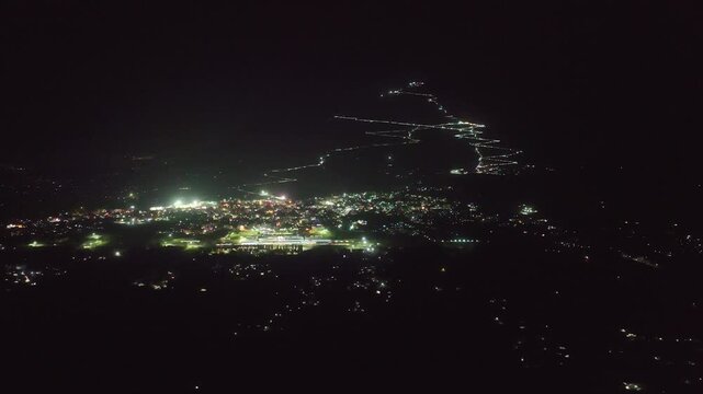 Night aerial orbit of illuminated Vaishno Devi trek in Trikuta hills, Katra, Jammu, India
