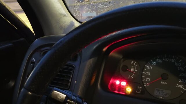 Moody nighttime setting showcasing illuminated dashboard and wet windows in cinematic quality