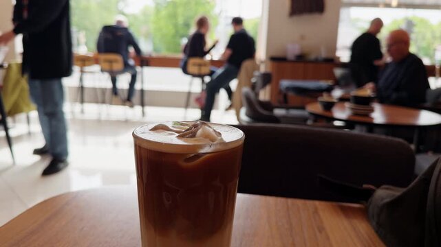 Chilled coffee gathering. Casual social gathering at cozy cafe with iced drinks and warm conversations