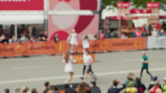 Running race captured. Vivid capturing of athlete sprinting through city streets with crowd cheering