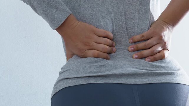 Woman suffering from waist, backache or hip pain. lower back while , chronic back pain, in office syndrome, scoliosis, herniated disc, muscle inflammation.	