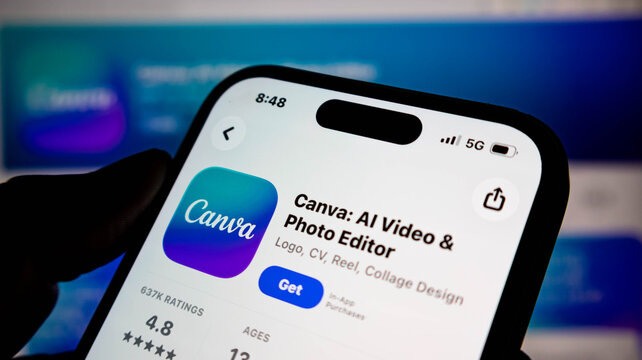 Closeup of a smartphone screen displaying the canva app page in the apple app store, showcasing its ai video and photo editing capabilities