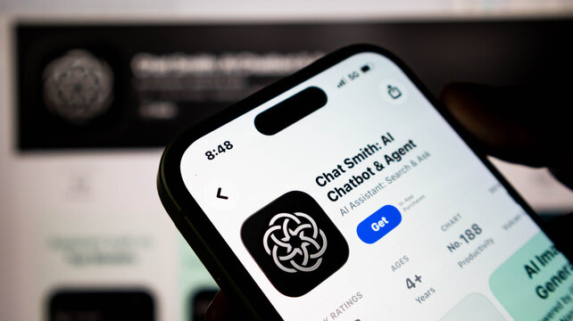 Closeup of a smartphone screen showing the chat smith ai chatbot app on the apple app store, with a blurred background