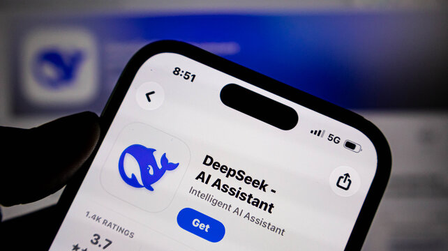 Closeup of a smartphone screen displaying the deepseek ai assistant app page in the app store, held by a persons hand