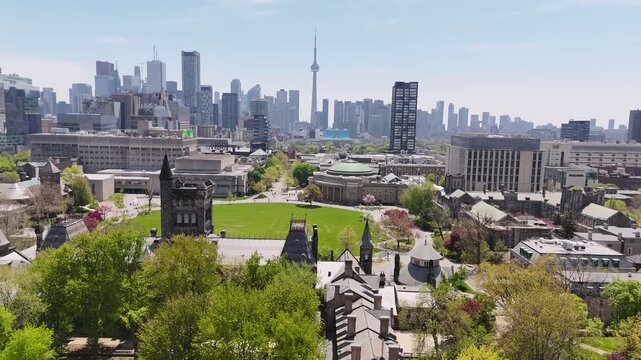 Drone aerial view flying forward over King's College Circle and tilting down to a close-up of the iconic domed Convocation Hall structure