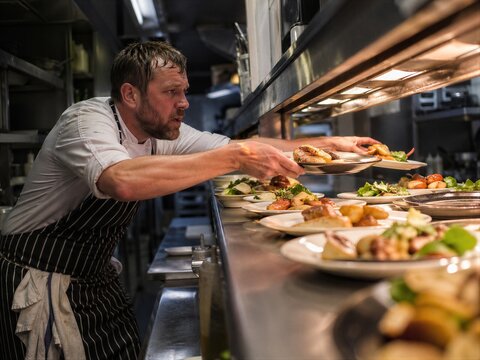Chef Preparing Dishes in Professional Kitchen