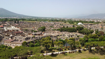 Fototapeta premium Panoramic drone shot over Pompeii ruins and Mount Vesuvius landscape in summer
