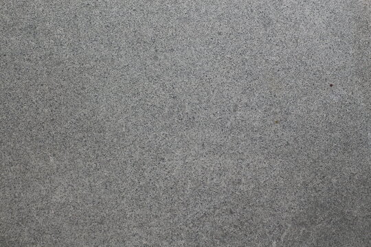 Close-up texture of speckled gray granite stone surface with fine grain