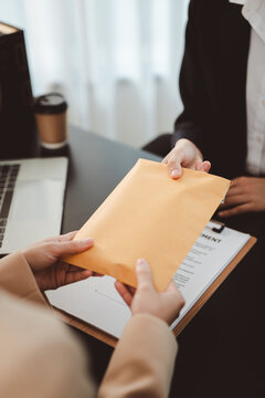 Business individuals exchanging a brown envelope, transferring illegal money or a secret document symbolizing corruption, illegal transactions, and corporate fraud