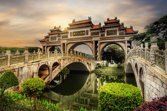 Foshan City, Guangdong, China. Shunfengshan Park, located at the foot of Taiping Mountain in Shunde District. Majestic traditional Chinese paifang gateway with elegant stone bridges.