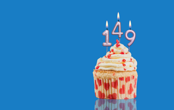 Birthday Or Anniversary Cupcake With Lit Candles; Candles Forming The Number 149
