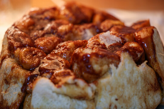 Delicious, gooey monkey bread fresh baked for a tasty breakfast. The sticky food is similar to a hot cinnamon roll or bun. 