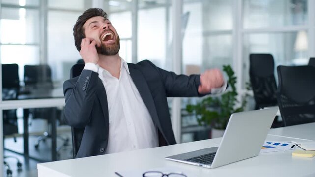 Caucasian funny mature business man laughing looking in mobile phone answer call middle-aged businessman laugh finishing using smartphone 40s male worker changing mood serious typing laptop at office