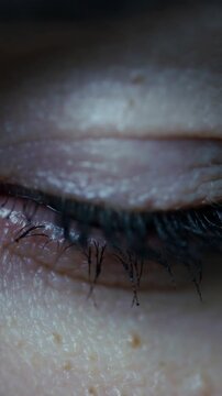 Vertical video: Recording, cam filming closed eyelid at home, showing eyelash shifts for skin study
