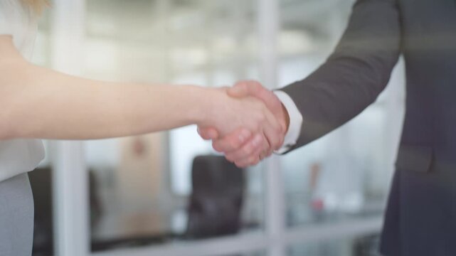 Caucasian business team handshaking close up in sunny office unrecognizable colleagues partners shaking hands greeting corporate formal deal partnership businessman with businesswoman handshake invest