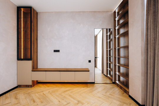 Open wardrobe featuring custom shelving and inviting illumination