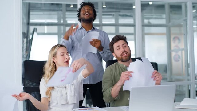 Corporate business group three multiracial colleagues dancing throwing papers celebrating weekend complete work singing happy in office diversity managers sing dance throw documents rejoicing job done