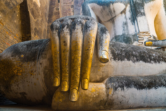 Giant Statue of A Seated Buddha With Tapered Fingers Covered With GoldFinger of Phra Ajana at Wat Si Chum, in Sukhothai historical park, SukhothaiThe most Beautiful Finger Buddha statue.